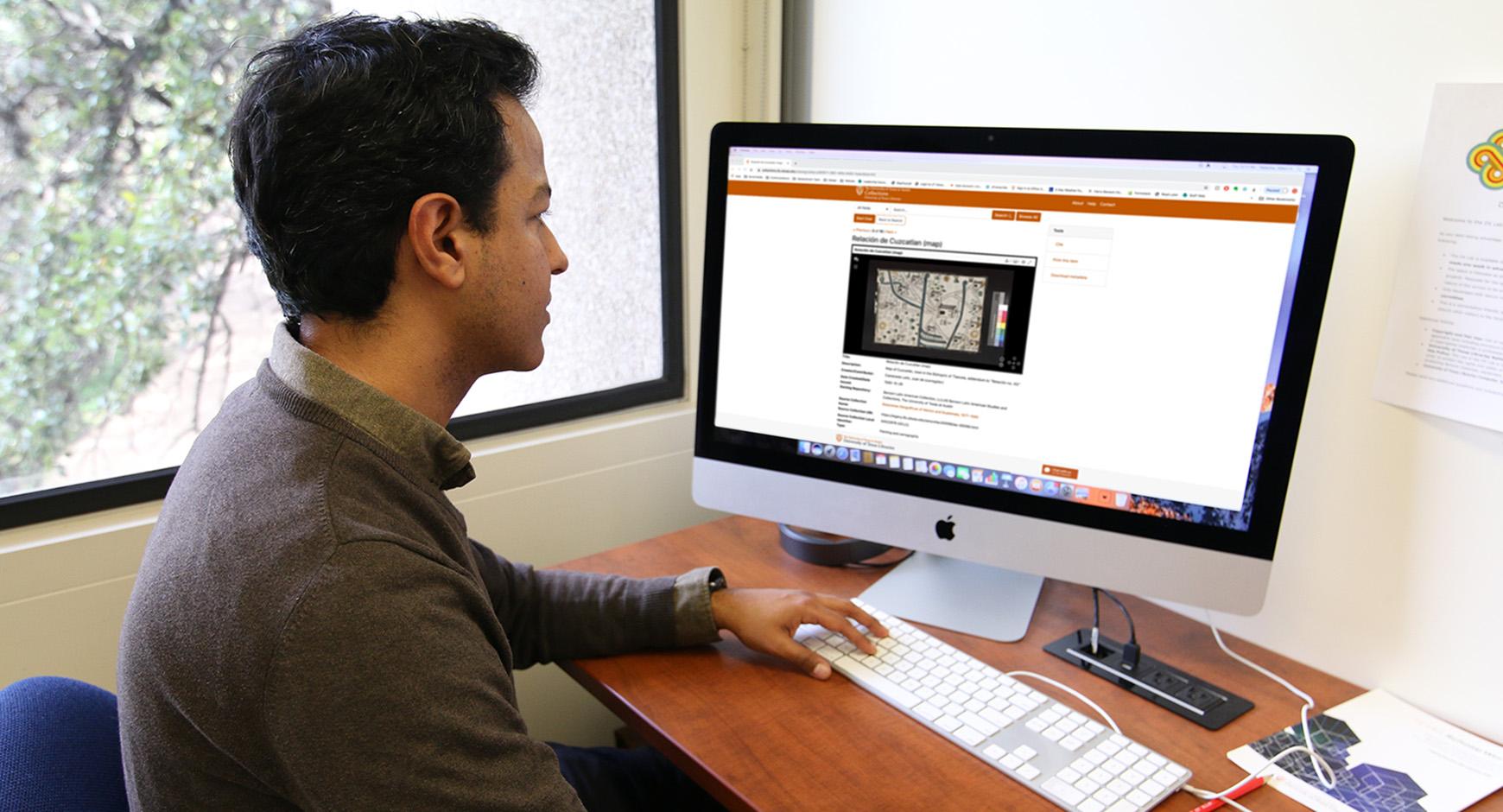 man viewing website on desktop computer