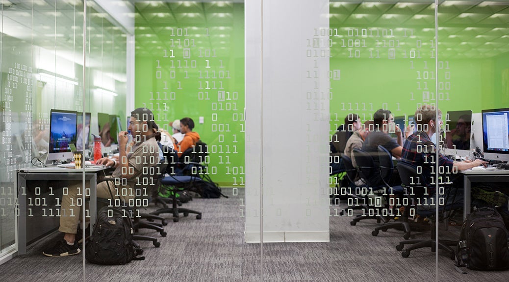 Library work area with green wall and computer stations