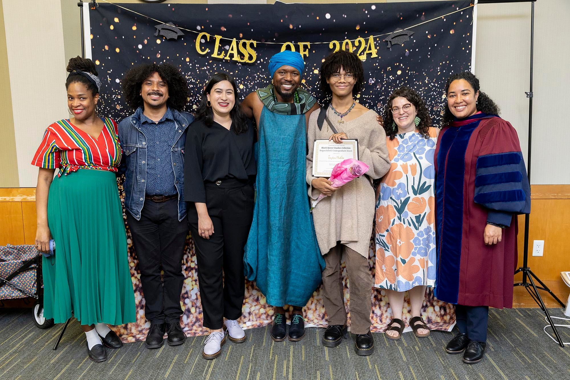 Image of award winners with Libraries' staff and faculty in front of "Class of 2024" banner.