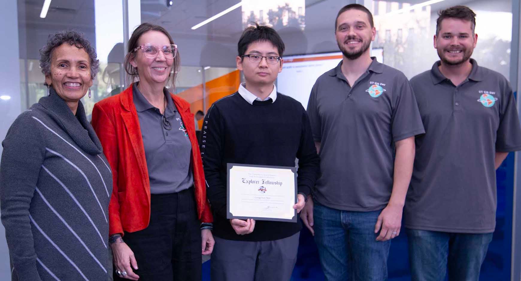 University of Texas Libraries research division staff members pose alongside Libraries Director Lorraine Haricombe (far left) and the 2024 Map & Geospatial Collections Explorer Fellowship faculty winner Dr. Gengchen Mai (center, holding a certificate), celebrating his achievement.