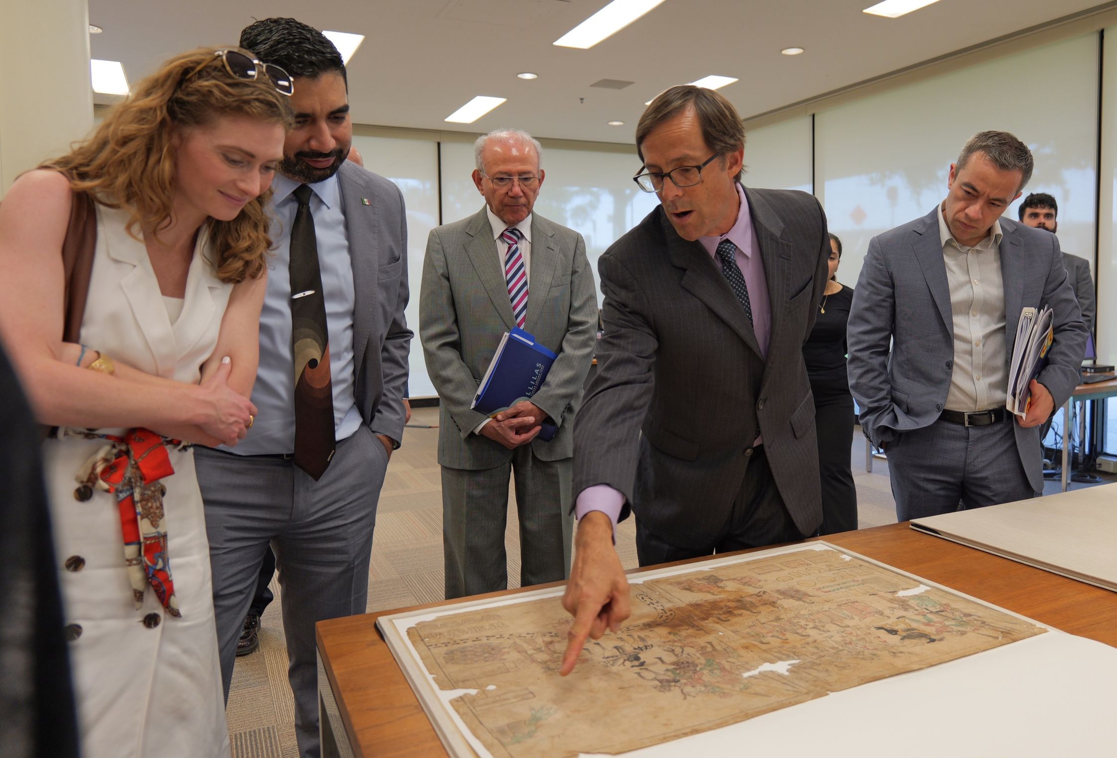 The Mexican ambassador to the U.S. examines rare materials from UT Austin's Latin American Collection.