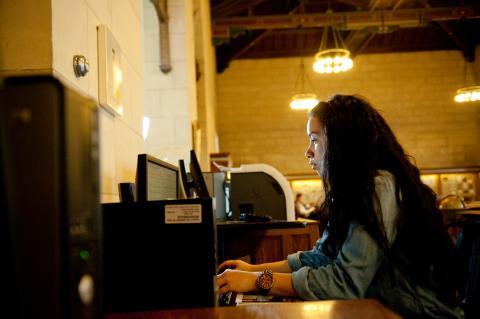 Student in front of a computer in a nicely bulb lit room