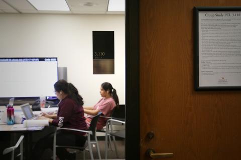 two students in a closed-door room