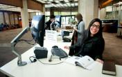 a smiling librarian behind an information desk