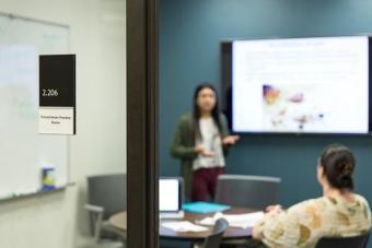 Person presenting in front of a whiteboard