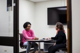 Two people discussing a project inside an office space