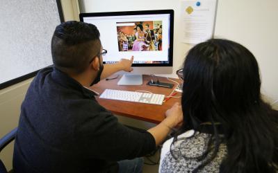 Two people in front of a computer