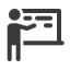 an icon of a person pointing to text on a blackboard