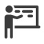 an icon of a person pointing to text on a blackboard