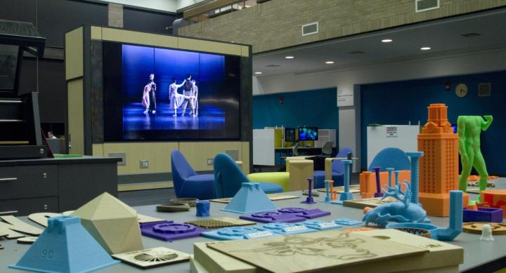 The image is view of the Video Wall from a Foundry maker station. In the foreground are different projects.