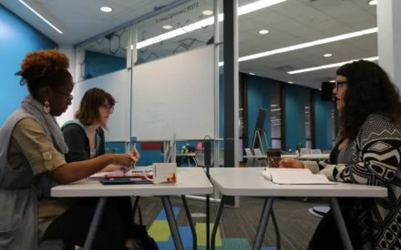 Students in a conversation at a table