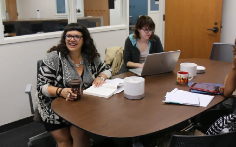 A photo of three students using a Graduate Student Group Study Room