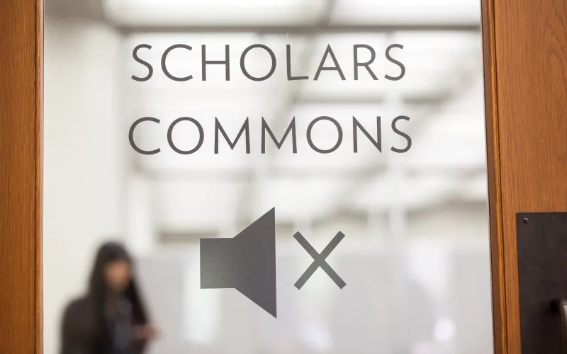 The Scholars Commons door which has a mute symbol signifying a quiet space